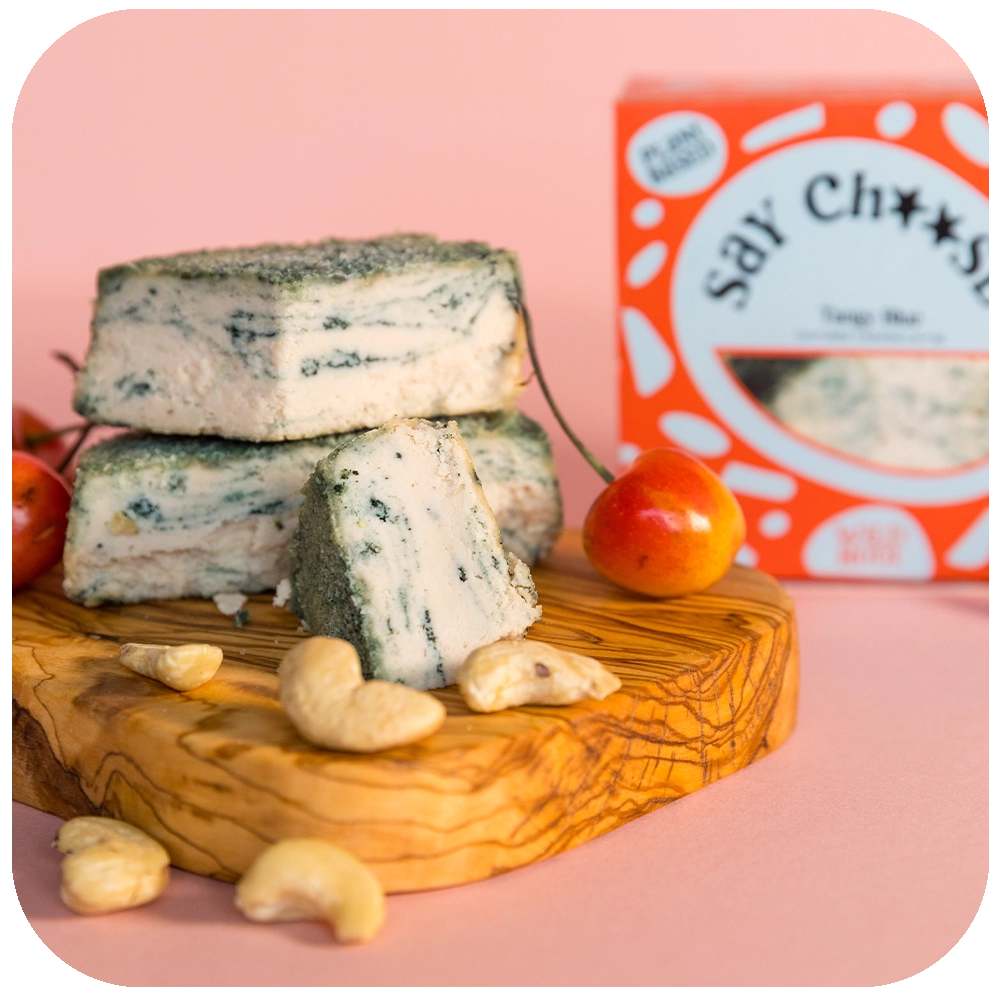 Tangy Vegan Cheese with cherries and nuts on the serving board 