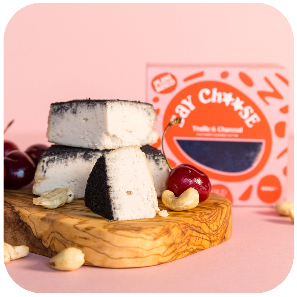 Truffle & Charcoal Cheese with grapes and nuts on the chopping board 